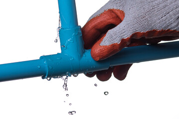 Man's hand holding blue pvc plastic pipe with a broken connection and water pouring out isolated on...