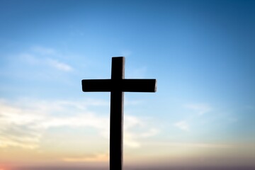 The wooden Cross at the sunset sky background