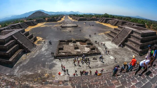 Zoom out time lapse view of tourists climbing the Pyramid of the Moon at the ancient Aztec city of Teotihuacan near Mexico City, Mexico.