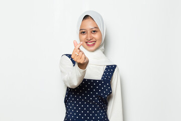 asian muslim woman wearing hijab showing heart sign
