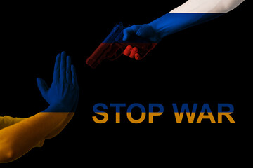 Ukrainian and russian hand flags with text stop war on black background. Russia fires Ukraine with...