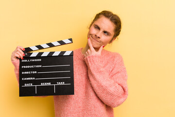 young pretty woman thinking, feeling doubtful and confused. cinema clapper concept