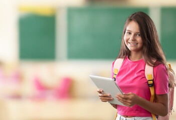 Fototapeta premium E-Learning. Happy School Girl Using Digital Tablet Doing Homework Online