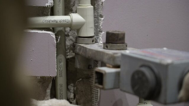 Connecting of pipes by melting using plastic pipe welding machine.  Brazing of pipes made of polycarbonate. Plumber installing pipes in home, ppr plastic pipe hot melt welding machine