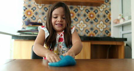 Fototapeta na wymiar Child hands playing with slime goo. Little girl close-up hand and fingers with sticky elastic plasticine