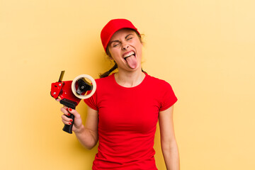 young pretty woman with cheerful and rebellious attitude, joking and sticking tongue out. packer...