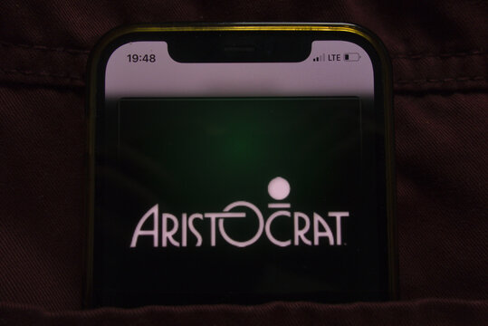 KONSKIE, POLAND - February 27, 2022: Aristocrat Leisure Limited logo on mobile phone hidden in jeans pocket