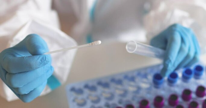 Process of coronavirus PCR antigen testing examination by nurse medic in laboratory lab, COVID-19 swab collection kit, test tube for taking OP NP patient specimen sample, patient receiving test, 4K 
