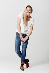 Shes happy-go-lucky. Full length studio portrait of a happy and attractive young woman.