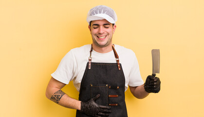 young handsome man laughing out loud at some hilarious joke. butcher concept