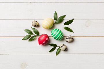 Colorful Easter eggs with spring flower leaf isolated over white background. Colored Egg Holiday border