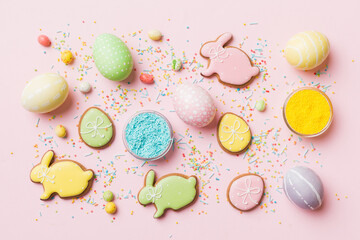holiday preparation Multi colors Easter eggs with cookies on colored background . Pastel color Easter eggs. holiday concept with copy space