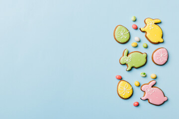 holiday preparation Multi colors Easter eggs with cookies on colored background . Pastel color Easter eggs. holiday concept with copy space