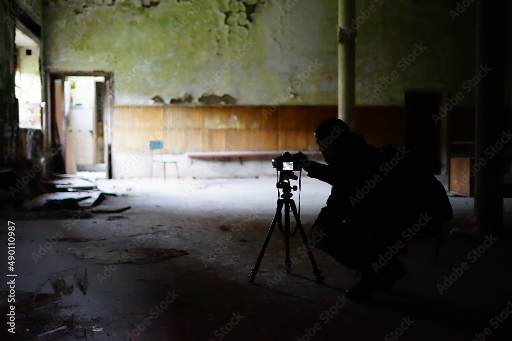 Wall mural photographer silouette in abandoned building