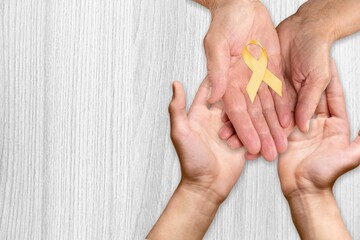 Hands of father and child hold a ribbon. Concept. World Multiple Sclerosis day.