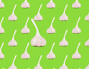 A collection of garlic and a creative pattern on a green background. The concept of healthy nutrition and dietary nutrition. A whole vegetable composition and a design element.