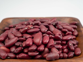 Red beans in a wooden bowl. Close-up.