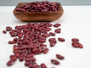 Red beans in a wooden bowl. Close-up.