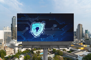 Padlock icon hologram on road billboard over panorama city view of Bangkok at day time to protect business, Southeast Asia. The concept of information security shields.