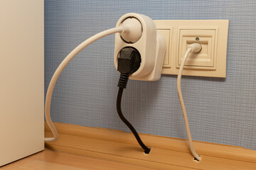 socket into which a tee and a power cord are plugged