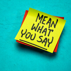 Mean what you say advice or reminder, handwriting on a sticky note, communication and personal development concept