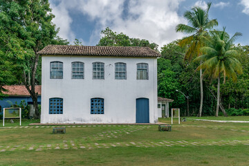 lindo casarão em centro histórico, com gramado em frente e mata ao fundo na frente da praia de cabrália Bahia