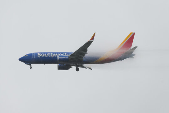 SeaTac, WA, USA - February 28, 2022; Southwest Airlines Boeing 737 MAX-8 landing in heavy rain with vapor vortex after flight from Chicago Midway to Seattle Tacoma