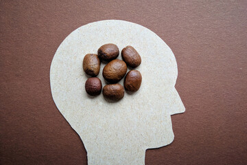 A man's head in profile with coffee instead of a brain, a profile of a man with poop instead of a...