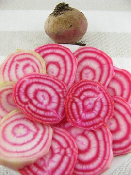 Slices raw chioggia beet on a plate