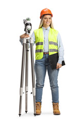 Full length portrait of a female geodetic surveyor posing with a measuring station