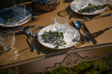Gorgeous vintage wedding table setting. Banquet. Table for guests, served with cutlery, flowers and crockery.