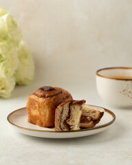 cut of the cruffin with cinnamon and cup of tea