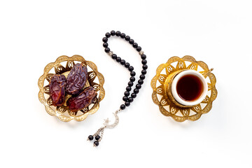 Ramadan Kareem background. Islamic rosary and dates fruits with tea