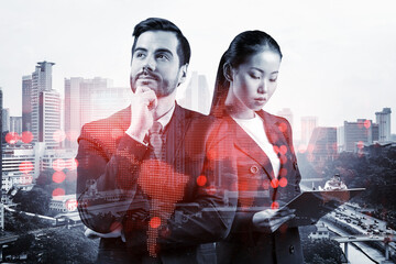 Businessman and businesswoman as a SMM specialists thinking about development of social media marketing strategy to achieve business goals. Hologram icons over Kuala Lumpur background.
