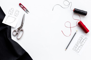 Sewing clothes knitwear in workshop with dress patterns with fabric