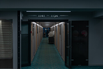 long corridor of a large hotel with a laundry cart in the distance
