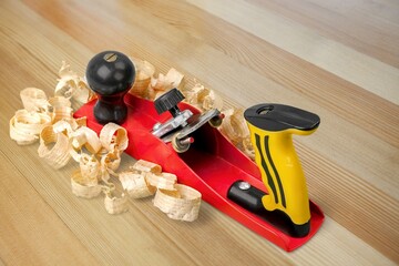 Plane jointer carpenter or joiner tool and wood shavings. Wood working tools on wooden table....