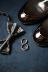 gold wedding rings on the wedding day for the newlyweds. Groom's accessories. Leather shoes for men