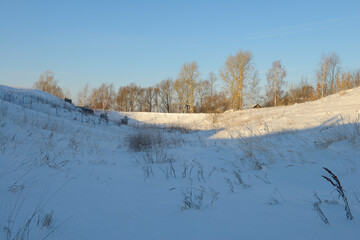 A snow-covered ravine on a sunny winter day