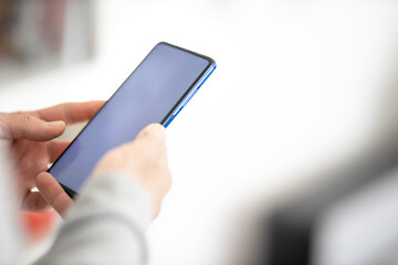 Male hands typing on smartphone