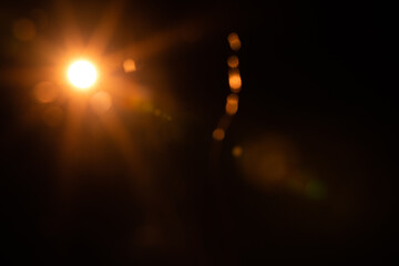 Fototapeta na wymiar Solar lens flare on black background