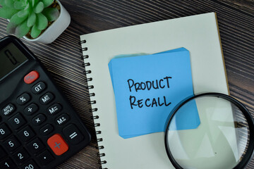 Product Recall write on sticky notes isolated on Wooden Table.