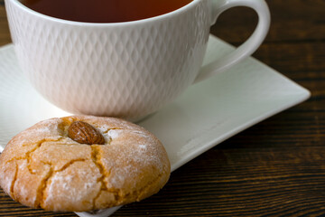 Gluten free italian cookies and a cup of tea. Almond cookie and a cup of tea. Sicilian traditional almond biscuit. Biscotti di mandorla siciliani.