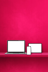 Laptop, mobile phone and digital tablet pc on pink wall shelf. Vertical background