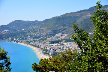Fototapeta premium cleopatra beach with sandline and blue sea, view from top on harbor and surrounding mountains