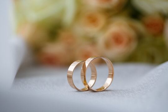 gold wedding rings on the wedding day for the newlyweds. Jewelry from expensive metal