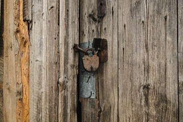 Old grunge textured wood background with a lock in the center, surface of old wood texture.