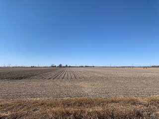 Fototapeta na wymiar Country Dirt Roads and Winter Corn Fields