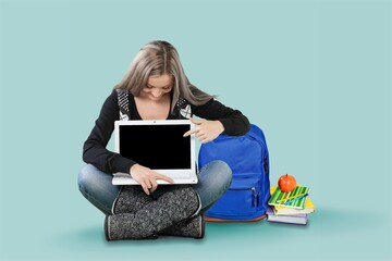 Sitting teenager schoolgirl with laptop computer, social media, e-learning remotely