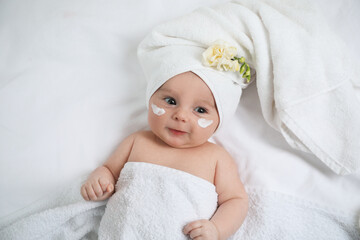 Cute little baby with cream on face, top view